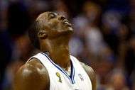 ORLANDO, FL - JUNE 11:  Dwight Howard #12 of the Orlando Magic reacts in Game Four of the 2009 NBA Finals against the Los Angeles Lakers on June 11, 2009 at Amway Arena in Orlando, Florida.  NOTE TO USER:  User expressly acknowledges and agrees that, by downloading and or using this photograph, User is consenting to the terms and conditions of the Getty Images License Agreement.  (Photo by Chris Graythen/Getty Images)