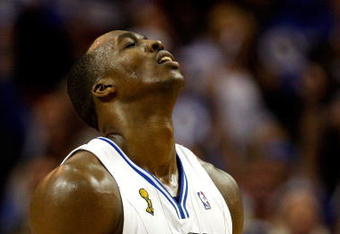 ORLANDO, FL - JUNE 11:  Dwight Howard #12 of the Orlando Magic reacts in Game Four of the 2009 NBA Finals against the Los Angeles Lakers on June 11, 2009 at Amway Arena in Orlando, Florida.  NOTE TO USER:  User expressly acknowledges and agrees that, by downloading and or using this photograph, User is consenting to the terms and conditions of the Getty Images License Agreement.  (Photo by Chris Graythen/Getty Images)