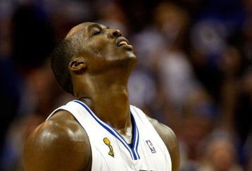 ORLANDO, FL - JUNE 11:  Dwight Howard #12 of the Orlando Magic reacts in Game Four of the 2009 NBA Finals against the Los Angeles Lakers on June 11, 2009 at Amway Arena in Orlando, Florida.  NOTE TO USER:  User expressly acknowledges and agrees that, by downloading and or using this photograph, User is consenting to the terms and conditions of the Getty Images License Agreement.  (Photo by Chris Graythen/Getty Images)
