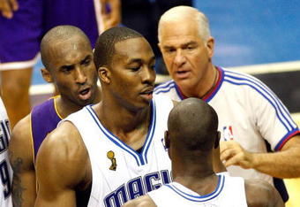 ORLANDO, FL - JUNE 11:  (L) Kobe Bryant #24 of the Los Angeles Lakers and (R) Mickael Pietrus #20 of the Orlando Magic exchange words as they are held back by Dwight Howard #12 of the Magic in Game Four of the 2009 NBA Finals on June 11, 2009 at Amway Arena in Orlando, Florida.  NOTE TO USER:  User expressly acknowledges and agrees that, by downloading and or using this photograph, User is consenting to the terms and conditions of the Getty Images License Agreement.  (Photo by Ronald Martinez/Getty Images)