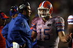 TALLAHASSEE, FL - NOVEMBER 29:  Head coach Urban Meyer of the Florida Gators chats with quarterback Tim Tebow #15 during a game against the Florida State Seminoles at Bobby Bowden Field at Doak Campbell Stadium on November 29, 2008 in Tallahassee, Florida. The Gators defeated the Seminoles 45-15.  (Photo by Marc Serota/Getty Images)