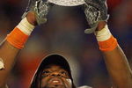 MIAMI - JANUARY 08:  Brandon Spikes #51 of the Florida Gators holds up the winning trophy after the FedEx BCS National Championship Game against the Oklahoma Sooners at Dolphin Stadium on January 8, 2009 in Miami, Florida.  (Photo by Eliot J. Schechter/Getty Images)