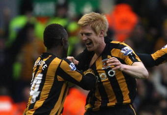 LIVERPOOL, UNITED KINGDOM - DECEMBER 13:  Paul McShane of Hull City celebrates scoring the opening goal with his team mate Kamil Zayatte (L) during the Barclays Premier League match between Liverpool and Hull City at Anfield on December 13, 2008 in Liverpool, England.  (Photo by Hamish Blair/Getty Images)