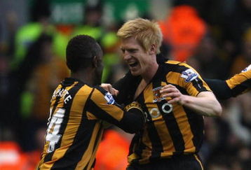 LIVERPOOL, UNITED KINGDOM - DECEMBER 13:  Paul McShane of Hull City celebrates scoring the opening goal with his team mate Kamil Zayatte (L) during the Barclays Premier League match between Liverpool and Hull City at Anfield on December 13, 2008 in Liverpool, England.  (Photo by Hamish Blair/Getty Images)
