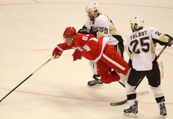 DETROIT - MAY 31:  Marian Hossa #81 of the Detroit Red Wings is tripped up between Sergei Gonchar #55 and Maxime Talbot #25 of the Pittsburgh Penguins  during Game Two of the 2009 Stanley Cup Finals at Joe Louis Arena on May 31, 2009 in Detroit, Michigan.  (Photo by Bruce Bennett/Getty Images)