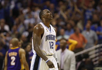 ORLANDO, FL - JUNE 11:  Dwight Howard #12 of the Orlando Magic head to the sideline during Game Four of the 2009 NBA Finals against the Los Angeles Lakers on June 11, 2009 at Amway Arena in Orlando, Florida. The Lakers won in overtime 99-91. NOTE TO USER:  User expressly acknowledges and agrees that, by downloading and or using this photograph, User is consenting to the terms and conditions of the Getty Images License Agreement. (Photo by Chris Graythen/Getty Images)
