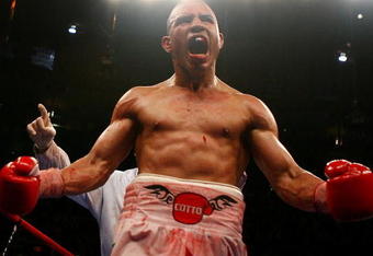NEW YORK - JUNE 09:  Miguel Cotto of Puerto Rico celebrates Zab Judah taking a knee during their WBA Welterweight Championship bout on June 9, 2007 at Madison Square Garden in New York City.  (Photo by Nick Laham/Getty Images)