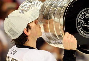 DETROIT - JUNE 12:  Evgeni Malkin #71 of the Pittsburgh Penguins celebrates with the Stanley Cup after defeating the Detroit Red Wings by a score of 2-1 to win Game Seven and the 2009 NHL Stanley Cup Finals at Joe Louis Arena on June 12, 2009 in Detroit, Michigan.  (Photo by Jim McIsaac/Getty Images)