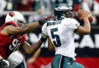 GLENDALE, AZ - JANUARY 18:  Quarterback Donovan McNabb #5 of the Philadelphia Eagles looks to avoid a sack from defensive end Darnell Dockett #90 of the Arizona Cardnals during the NFC championship game on January 18, 2009 at University of Phoenix Stadium in Glendale, Arizona.  (Photo by Jamie Squire/Getty Images)