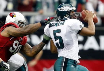 GLENDALE, AZ - JANUARY 18:  Quarterback Donovan McNabb #5 of the Philadelphia Eagles looks to avoid a sack from defensive end Darnell Dockett #90 of the Arizona Cardnals during the NFC championship game on January 18, 2009 at University of Phoenix Stadium in Glendale, Arizona.  (Photo by Jamie Squire/Getty Images)