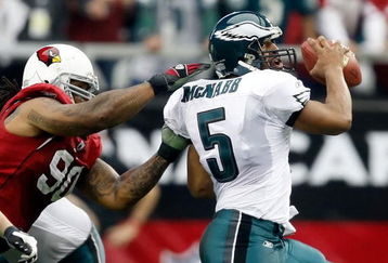 GLENDALE, AZ - JANUARY 18:  Quarterback Donovan McNabb #5 of the Philadelphia Eagles looks to avoid a sack from defensive end Darnell Dockett #90 of the Arizona Cardnals during the NFC championship game on January 18, 2009 at University of Phoenix Stadium in Glendale, Arizona.  (Photo by Jamie Squire/Getty Images)