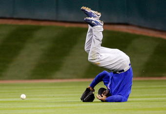 HOUSTON - APRIL 06:  Milton Bradley #21 of the Chicago Cubs flips over after missing a fly ball against the Houston Astros on Opening Day on April 6, 2009 at Minute Maid Park in Houston, Texas.  The Cubs defeated the Astros 4-2.  (Photo by Chris Graythen/Getty Images)