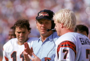 ANAHEIM, CA - OCTOBER 7:  Head coach Sam Wyche of the Cincinnati Bengals talks to his quarterback Boomer Esiason #7 on the sidelines during a game against the Los Angeles Rams at the Anaheim Stadium on October 7, 1990 in Anaheim, California.  The Bengals won 34-31.  (Photo by George Rose/Getty Images)