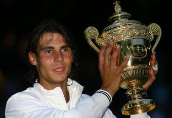 LONDON - JULY 06:  Rafael Nadal of Spain celebrates with the trophy winning the Championship during the men's singles Final match against Roger Federer of Switzerland on day thirteen of the Wimbledon Lawn Tennis Championships at the All England Lawn Tennis and Croquet Club on July 6, 2008 in London, England.  (Photo by Clive Brunskill/Getty Images)