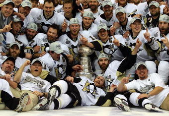 DETROIT - JUNE 12:  The Pittsburgh Penguins celebrates with the Stanley Cup after defeating the Detroit Red Wings by a score of 2-1 to win Game Seven and the 2009 NHL Stanley Cup Finals at Joe Louis Arena on June 12, 2009 in Detroit, Michigan.  (Photo by Jim McIsaac/Getty Images)