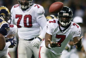 6 Jan 2002: Quarterback Michael Vick #7 of  the Atlanta Falcons fumbles the ball as Leonard Little #91 of the St. Louis Rams defends at the Dome at America's Center in St. Louis, Missouri. The Rams recovered the fumble. The St. Louis Rams beat the Atlanta Falcons 31-13.  DIGITAL IMAGE. Mandatory Credit: Elsa /Getty Images