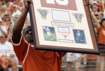 AUSTIN, TX - AUGUST 30:  Quarterback Vince Young of the Tennessee Titans, holds up his Texas Longhorns jersey as his number is retired before a game against the Florida Atlantic Owls at Darrell K Royal-Texas Memorial Stadium on August 30, 2007 in Austin, Texas.  (Photo by Brian Bahr/Getty Images)