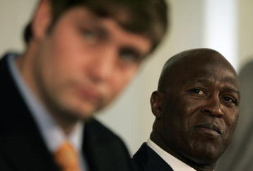 LAKE FOREST, IL - APRIL 3:  Chicago Bears head coach Lovie Smith looks on as new quarterback Jay Cutler talks to the media  during a press conference on April 3, 2009 at Halas Hall in Lake Forest, Illinois. (Photo by Jim Prisching/Getty Images)
