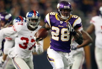 MINNEAPOLIS - DECEMBER 28:   Adrian Peterson #28 of the Minnesota Vikings runs the ball in for a touchdown as James Butler of the New York Giants defends on December 28, 2008 at the Hubert H. Humphrey Metrodome in Minneapolis, Minnesota. The Vikings defeated the Giants 20-19. (Photo by Elsa/Getty Images)