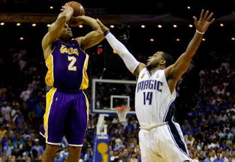 ORLANDO, FL - JUNE 11:  Derek Fisher #2 of the Los Angeles Lakers shoots a game-tying three-point shot over Jameer Nelson #14 of the Orlando Magic in the fourth quarter of Game Four of the 2009 NBA Finals on June 11, 2009 at Amway Arena in Orlando, Florida.  NOTE TO USER:  User expressly acknowledges and agrees that, by downloading and or using this photograph, User is consenting to the terms and conditions of the Getty Images License Agreement.  (Photo by Chris Graythen/Getty Images)