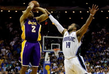 ORLANDO, FL - JUNE 11:  Derek Fisher #2 of the Los Angeles Lakers shoots a game-tying three-point shot over Jameer Nelson #14 of the Orlando Magic in the fourth quarter of Game Four of the 2009 NBA Finals on June 11, 2009 at Amway Arena in Orlando, Florida.  NOTE TO USER:  User expressly acknowledges and agrees that, by downloading and or using this photograph, User is consenting to the terms and conditions of the Getty Images License Agreement.  (Photo by Chris Graythen/Getty Images)