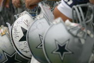 OXNARD, CA - JULY 29:  Fans of the Dallas Cowboys wait for players to sign their Cowboy helmets during the first day of training camp for the Cowboys on July 29, 2006 at the River Ridge Field in Oxnard, California.  (Photo by Stephen Dunn/Getty Images)