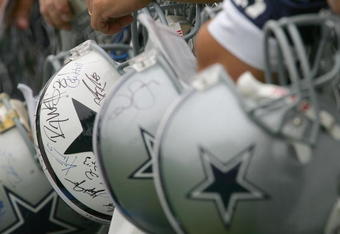 OXNARD, CA - JULY 29:  Fans of the Dallas Cowboys wait for players to sign their Cowboy helmets during the first day of training camp for the Cowboys on July 29, 2006 at the River Ridge Field in Oxnard, California.  (Photo by Stephen Dunn/Getty Images)