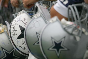 OXNARD, CA - JULY 29:  Fans of the Dallas Cowboys wait for players to sign their Cowboy helmets during the first day of training camp for the Cowboys on July 29, 2006 at the River Ridge Field in Oxnard, California.  (Photo by Stephen Dunn/Getty Images)