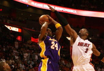 MIAMI - DECEMBER 19:  Kobe Bryant #24 of the Los Angeles Lakers has his shot altered by the defense of Dwyane Wade #3 and Mario Chalmers #6 of the Miami Heat at American Airlines Arena on December 19, 2008 in Miami, Florida. NOTE TO USER: User expressly acknowledges and agrees that, by downloading and/or using this Photograph, user is consenting to the terms and conditions of the Getty Images License Agreement.  (Photo by Doug Benc/Getty Images)