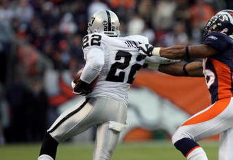 DENVER - NOVEMBER 23:  Justin Miller #22 of the Oakland Raiders returns the a kick off as Jack Williams #26 of the Denver Broncos makes the tackle during week 12 NFL action at Invesco Field at Mile High on November 23, 2008 in Denver, Colorado. The Raiders defeated the Broncos 31-10. The Raiders defeated the Broncos 31-10.  (Photo by Doug Pensinger/Getty Images)