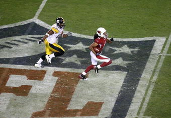 TAMPA, FL - FEBRUARY 01:  Larry Fitzgerald #11 of the Arizona Cardinals scores on a 64-yard touchdown reception in the fourth quarter against James Harrison #92 of the Pittsburgh Steelers during Super Bowl XLIII on February 1, 2009 at Raymond James Stadium in Tampa, Florida. Steelers won 27-23.  (Photo by Doug Benc/Getty Images)