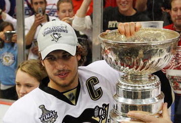 DETROIT - JUNE 12:  Sidney Crosby #87 of the Pittsburgh Penguins celebrates with the Stanley Cup after defeating the Detroit Red Wings by a score of 2-1 to win Game Seven and the 2009 NHL Stanley Cup Finals at Joe Louis Arena on June 12, 2009 in Detroit, Michigan.  (Photo by Jim McIsaac/Getty Images)