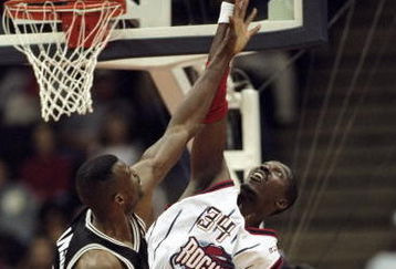 26 Jan 1999: Hakeem Olajuwon #34 of the Houston Rockets tips the ball during the game against the San Antonio Spurs at the Compaq Center in Houston, Texas. The Spurs defeated the Rockets 106-99.