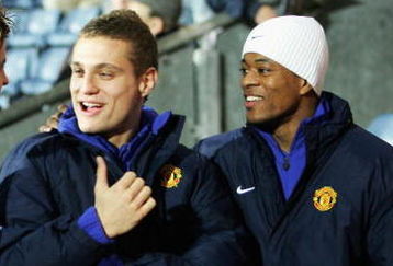 BLACKBURN, UNITED KINGDOM - JANUARY 11: New signings Nnmanja Vidic and Patrice Evra of Manchester United share a joke during the Carling Cup Semi Final match between Blackburn Rovers and Manchester United on January 11, 2006 at Ewood Park in Blackburn, England.   (Photo by Laurence Griffiths/Getty Images)