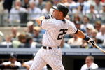 NEW YORK - APRIL 17:  Mark Teixeira #25 of the New York Yankees hits a home run in the third inning against the Cleveland Indians at Yankee Stadium on April 17, 2009 in the Bronx borough of New York City.  (Photo by Ezra Shaw/Getty Images)