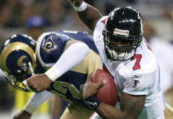 6 Jan 2002: Michael Vick #7 of the Atlanta Falcons scrambles as Chidi Ahanotu #72 of the St. Louis Rams defends at the Dome at America's Center in St. Louis, Missouri. The St. Louis Rams beat the Atlanta Falcons 31-13.  DIGITAL IMAGE. Mandatory Credit: Elsa /Getty Images