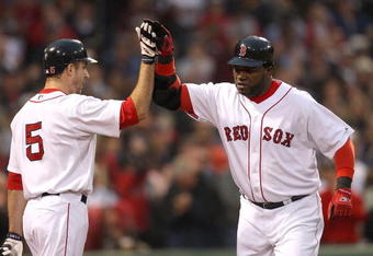 BOSTON - JUNE 11:  David Ortiz #34 of the Boston Red Sox hits a home run and celebrates with teammate Rocco Baldelli against the New York Yankees at Fenway Park on June 11, 2009 in Boston, Massachusetts.  (Photo by Jim Rogash/Getty Images)