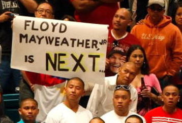 LAS VEGAS - MAY 01:  A sign for Floyd Mayweather Jr. is held as boxing fans wait for the official weigh-in for the junior welterweight title fight between Ricky Hatton of England and Manny Pacquiao of the Philippines at the MGM Grand Garden Arena May 1, 2009 in Las Vegas, Nevada. It was reported that on May 2 Mayweather will announce the end of his retirement to fight Juan Manuel Marquez.  (Photo by Ethan Miller/Getty Images)