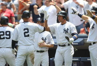 NEW YORK - JUNE 14:  Derek Jeter #2 of the New York Yankees celebrates scoring on a Johnny Damon single in the second inning with teammate Alex Rodriguez #13 against the New York Mets on June 14, 2009 at Yankee Stadium in the Bronx borough of New York City.  (Photo by Nick Laham/Getty Images)