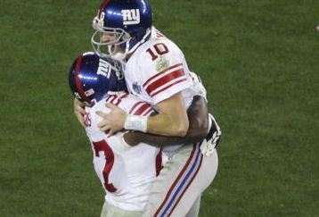 GLENDALE, AZ - FEBRUARY 03:  Quarterback Eli Manning #10 of the New York Giants celebrates with running back Brandon Jacobs #27 after Manning throws to wide receiver Plaxico Burress #17 of the New York Giants as Burress catches a 13-yard touchdown pass in the fourth quarter over Ellis Hobbs #27 of the New England Patriots during Super Bowl XLII on February 3, 2008 at the University of Phoenix Stadium in Glendale, Arizona.  The Giants defeated the Patriots 17-14.  (Photo by Jim McIsaac/Getty Images)