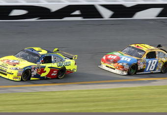DAYTONA BEACH, FL - FEBRUARY 12:  Mark Martin, driver of the #5 Kellogg's/CARQUEST Chevrolet, races Kyle Busch, driver of the #18 M&M's Toyota, during the NASCAR Sprint Cup Series Gatorade Duel 2 at Daytona International Speedway on February 12, 2009 in Daytona Beach, Florida.  (Photo by Geoff Burke/Getty Images for NASCAR)