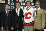NASHVILLE, TN - JUNE 21:  (L to R) Mike Sands, Tod Button, first round (#9 overall) draft pick Dion Phaneuf, and Darryl Sutter of the Calgary Flames pose for a portrait on stage during the 2003 NHL Entry Draft at the Gaylord Entertainment Center on June 21, 2003 in Nashville, Tennessee. (Photo by Elsa/Getty Images/NHLI)