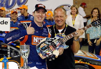 NASHVILLE, TN - JUNE 06:  Kyle Busch, driver of the #18 NOS Energy Drink Toyota poses for a photo with Artist Sam Bass after winning the NASCAR Nationwide Series Federated Auto Parts 300 at the Nashville Superspeedway on June 6, 2009 in Lebanon,Tennessee.  (Photo by Chris Graythen/Getty Images for NASCAR)