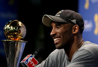 ORLANDO, FL - JUNE 14:  Kobe Bryant #24 of the Los Angeles Lakers smiles during the post game news conference after the Lakers defeated the Orlando Magic 99-86 to win the NBA Championship in Game Five of the 2009 NBA Finals on June 14, 2009 at Amway Arena in Orlando, Florida.  NOTE TO USER:  User expressly acknowledges and agrees that, by downloading and or using this photograph, User is consenting to the terms and conditions of the Getty Images License Agreement.  (Photo by Elsa/Getty Images)