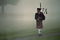 28 Oct 1999: A bag pipper walks in the morning fog at Payne Stewart's Memorial before The Tour Championship at the Champions Golf Club in Houston, Texas.