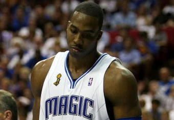 ORLANDO, FL - JUNE 14:  Dwight Howard #12 of the Orlando Magic looks down in the fourth quarter as the Magic trail the Los Angeles Lakers in Game Five of the 2009 NBA Finals on June 14, 2009 at Amway Arena in Orlando, Florida.  NOTE TO USER:  User expressly acknowledges and agrees that, by downloading and or using this photograph, User is consenting to the terms and conditions of the Getty Images License Agreement.  (Photo by Elsa/Getty Images)