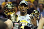 ORLANDO, FL - JUNE 14:  Kobe Bryant #24 of the Los Angeles Lakers holds up the Larry O'Brien trophy and the MVP trophy after the Lakers defeated the Orlando Magic 99-86 in Game Five of the 2009 NBA Finals on June 14, 2009 at Amway Arena in Orlando, Florida.  NOTE TO USER:  User expressly acknowledges and agrees that, by downloading and or using this photograph, User is consenting to the terms and conditions of the Getty Images License Agreement.  (Photo by Ronald Martinez/Getty Images)