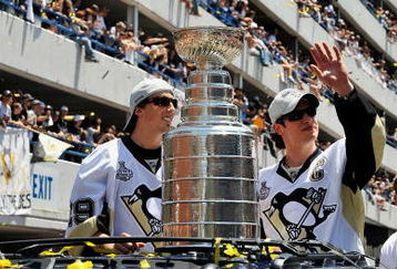 PITTSBURGH - JUNE 15:  Marc-Andre Fleury #29 and Sidney Crosby #87 of the Pittsburgh Penguins show off the Stanley Cup to the crowd on the Blvd of the Allies during the Stanley Cup Champion Victory Parade on June 15, 2009 in Pittsburgh, Pennsylvania.  (Photo by Jamie Sabau/Getty Images)