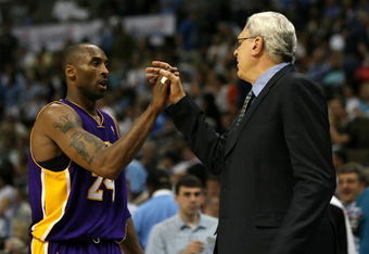 DENVER - MAY 29:  (L-R) Kobe Bryant #24 of the Los Angeles Lakers shakes hands with head coach Phil Jackson as Bryant is taken out of the game in the fourth quarter against the Denver Nuggets in Game Six of the Western Conference Finals during the 2009 NBA Playoffs at Pepsi Center on May 29, 2009 in Denver, Colorado. NOTE TO USER: User expressly acknowledges and agrees that, by downloading and or using this photograph, User is consenting to the terms and conditions of the Getty Images License Agreement.  (Photo by Doug Pensinger/Getty Images)