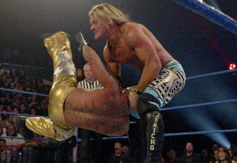 LAS VEGAS - DECEMBER 2:  (U.S. TABLOIDS OUT)   WWE wrestlers Rey Mysterio (in gold) and Chris Jericho perform on stage during the '1st Annual Video Game Awards' at the MGM Grand Garden Arena December 2, 2003 in Las Vegas, Nevada.  The show premieres on Spike T.V. Thursday, December 4 at 9:00PM ET/PT.  (Photo by Frank Micelotta/Getty Images)